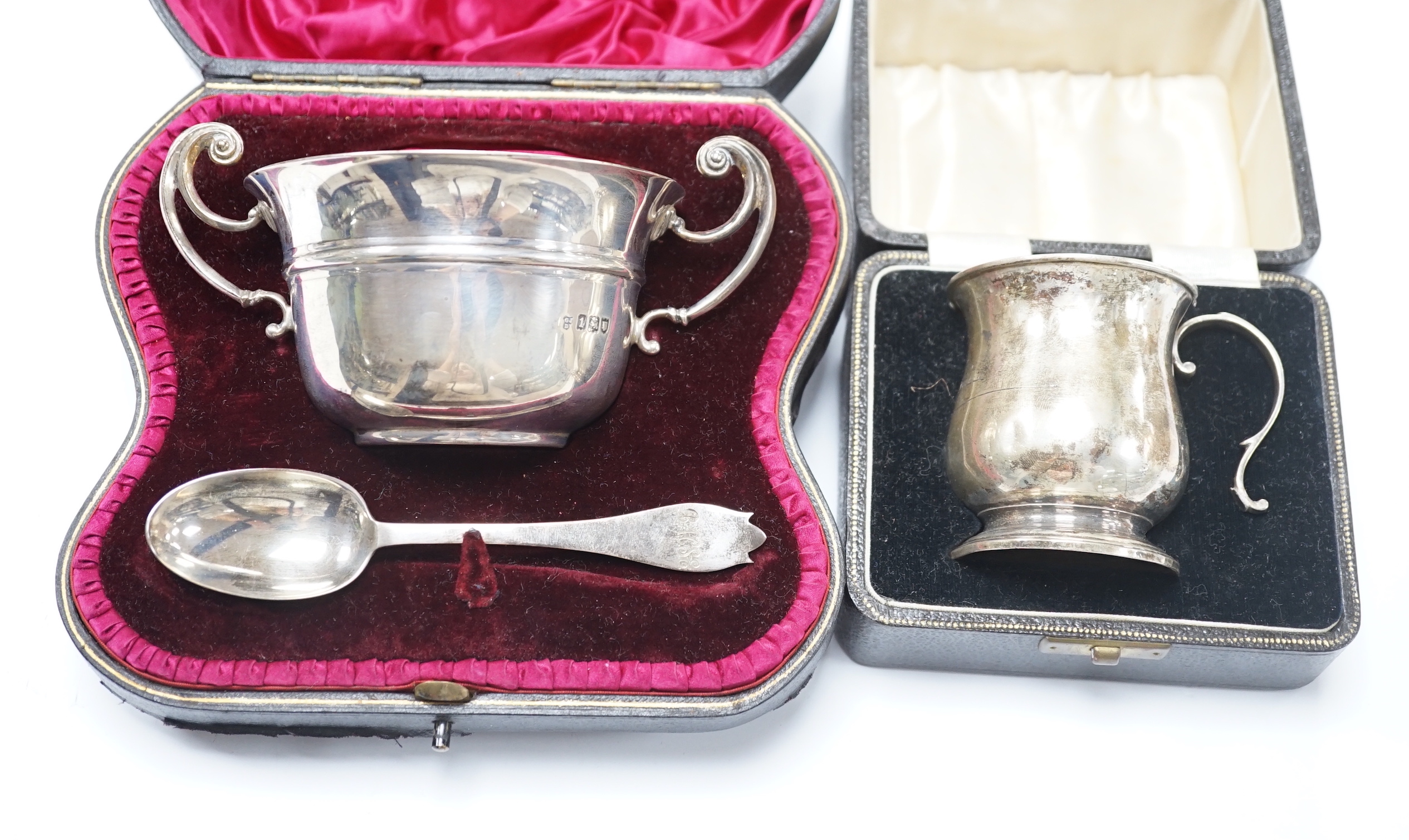 A cased Edwardian silver porringer and spoon, London, 1906 and a cased damaged silver christening mug.